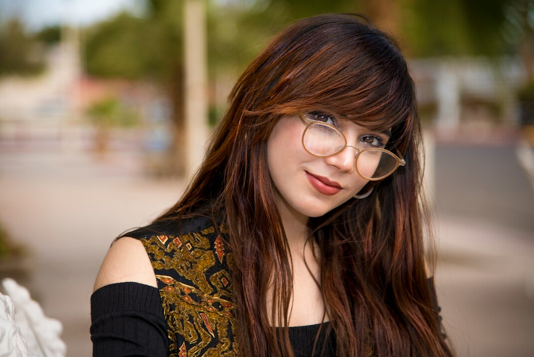 Casual portrait of a young woman with glasses smiling