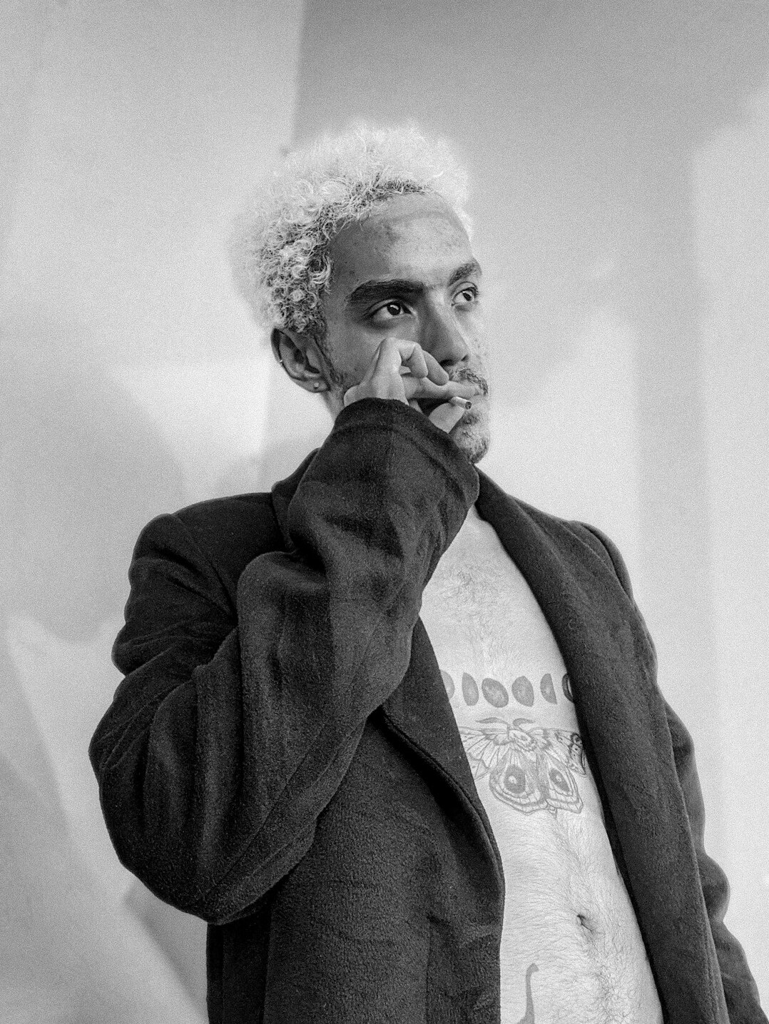 Studio portrait of an older man with grey hair in a blazer